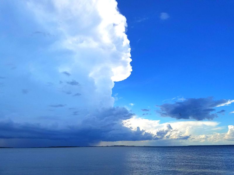 Huge storm clouds take over a blue sky at Tybee Island Beach, Georgia