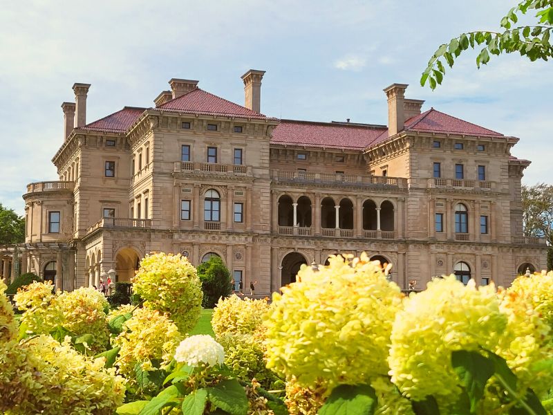 The Breakers as seen from the back lawn in the afternoon sun with white hydrangeas in bloom