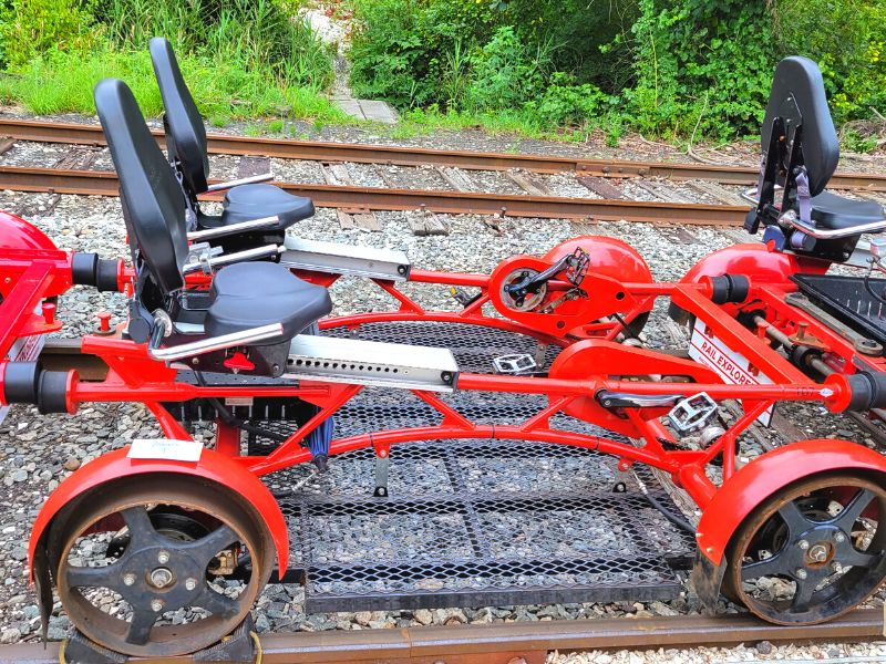 A red pedal rail car sits on the tracks at Newport's Rail Explorers