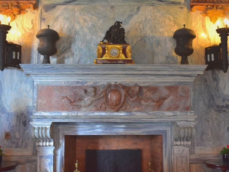 Blue and red marble cover the walls and fireplace in The Breakers billiards room in Newport