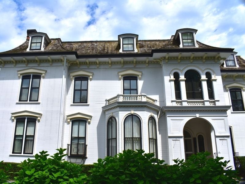 Chepstow's white siding glows in the sun, a more modest Newport Mansion