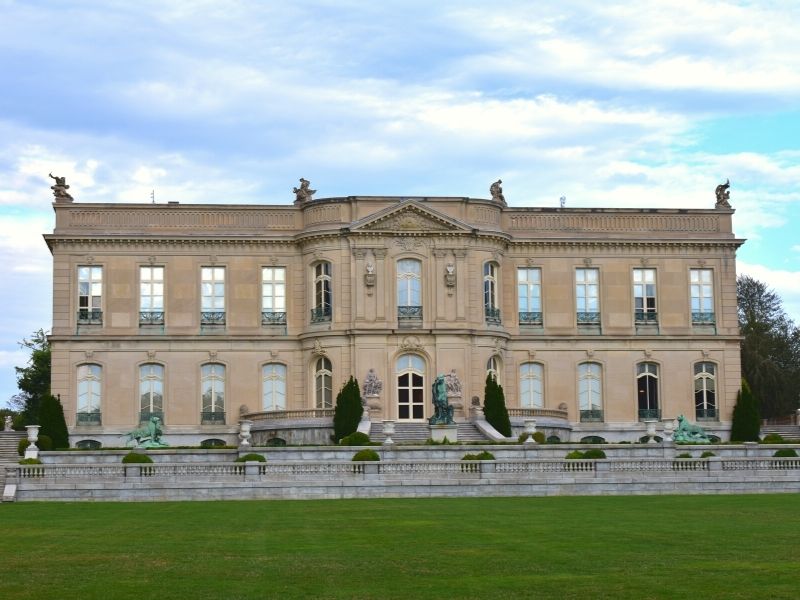 The back stone facade with terraces of The Elms mansion in Newport, RI