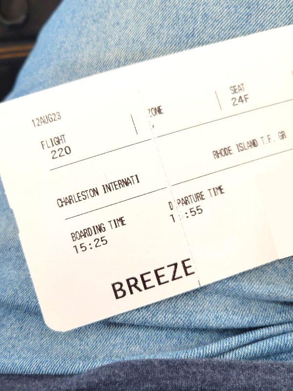 A printed boarding pass for a Breeze flight