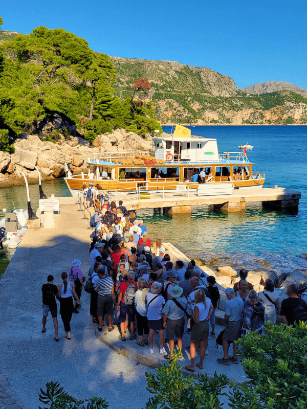 A line of passengers wait to board the ferry back to Dubrovnik from Lokrum Island
