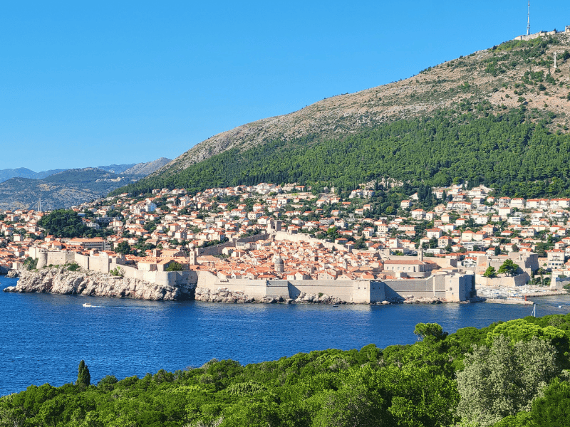 A wide view of Dubrovnik's old town on the water from a viewpoint on Lokrum Island